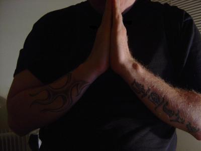 Tattooed praying arms...